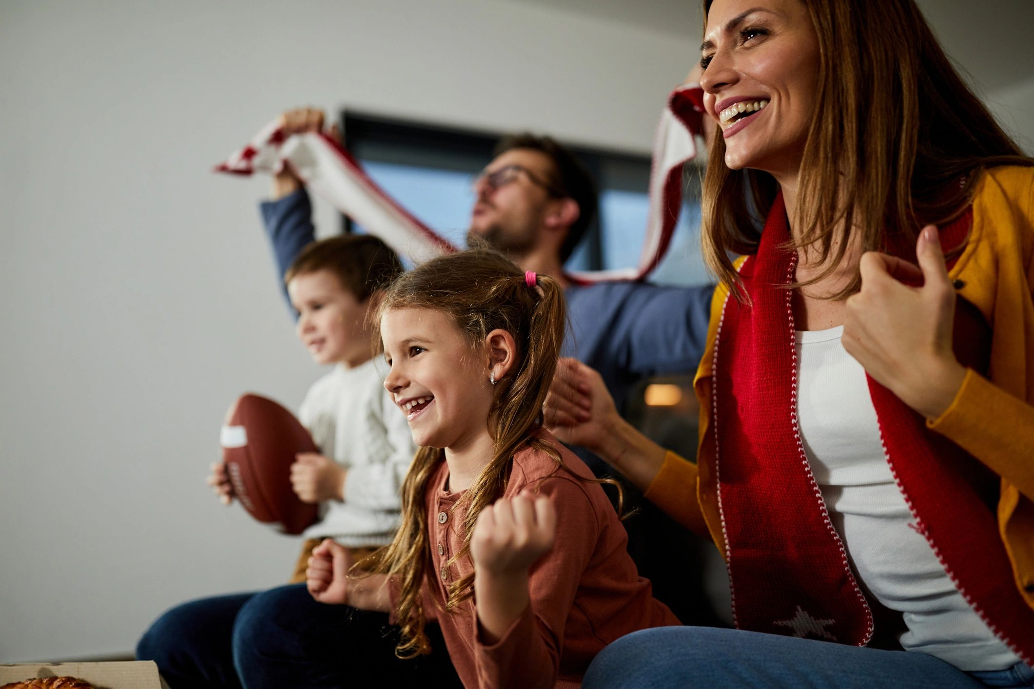 Fans watching an NFL game in a vibrant game room